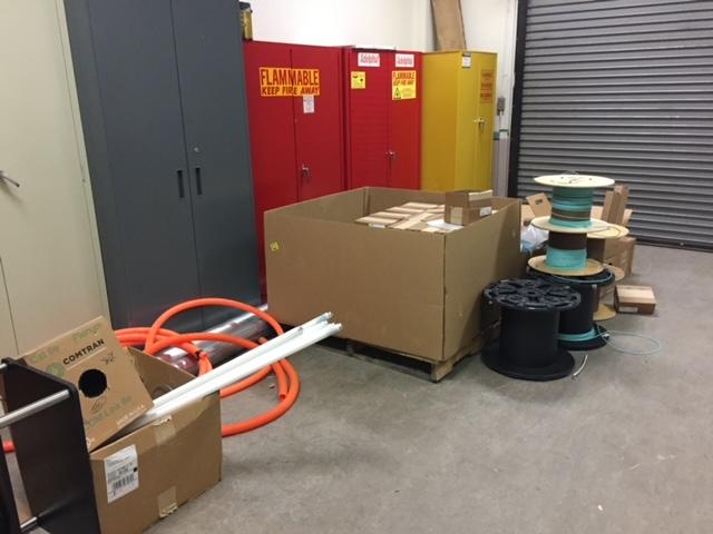 Poor housekeeping having storage in front of hazardous material storage and blocking egress
